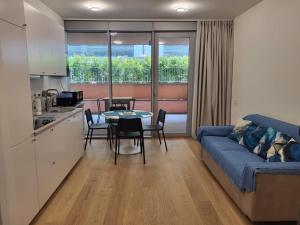 a living room with a blue couch and a table at Waterfront Porto Antico House in Genoa