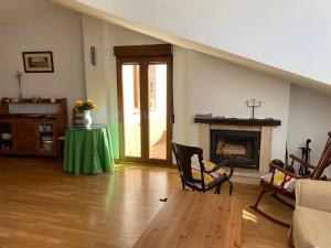 a living room with a table and a fireplace at Ático con chimenea en Bronchales in Bronchales