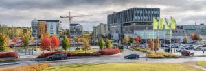 a city with cars parked in a parking lot at Comfort Us 2 - Cozy Private Home in Uppsala