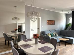 a living room with a couch and a table at Diamond Apartment in Grudziądz