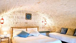 Llit o llits en una habitació de Trulli Panoramici