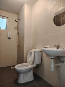 a bathroom with a toilet and a sink at J&K Guesthouse at Harmoni Apartment, Eco Majestic in Beranang