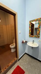 a bathroom with a toilet and a sink at Remedy in Lagas in Ubud
