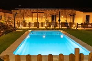 a swimming pool in a yard at night at Casa Hoces - Alma del Cabriel in El Herrumblar