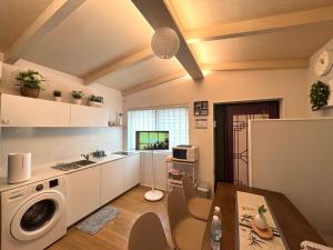 a kitchen with a washer and dryer in a room at Hello Stay & Hangang Park, 5 min walk from Konkuk University, Seongsu, Jayang Subway Stations & Licensed Accommodation in Seoul