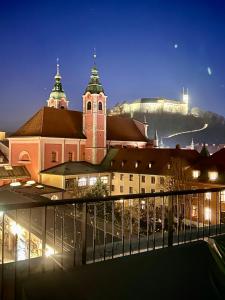 a large building with a clock tower in a city at Castle View Penthouse in Ljubljana