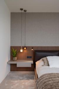 a bedroom with a bed and a table with a plant at Castle View Penthouse in Ljubljana