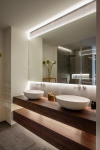 two sinks on a wooden counter in a bathroom at Castle View Penthouse in Ljubljana +8 photos