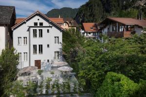 a white building with umbrellas in a village at BetweenLakes Apartment 1st floor in Interlaken