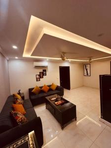 a living room with a couch and a coffee table at Bahria Eiffel Apartments in Lahore