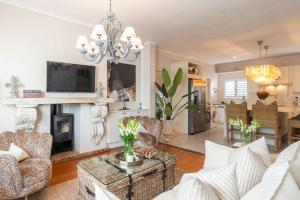 a living room with a couch and a fireplace at Ukuthula - Tranquil home in Hout Bay, Cape Town in Hout Bay