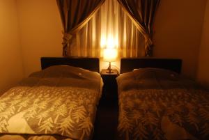 A bed or beds in a room at 風香る森のホテル鈴桃rindou