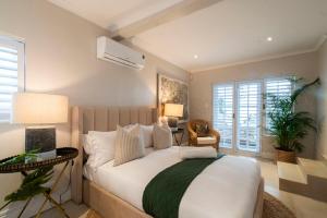 a bedroom with a large bed and two lamps at Ukuthula - Tranquil home in Hout Bay, Cape Town in Hout Bay +108 photos