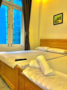 Ένα ή περισσότερα κρεβάτια σε δωμάτιο στο Đảo Bình Ba, căn hộ Trắng có BẾP, gần biển, không nhận khách quốc tế, 2 phòng đôi, nhận cọc trước mới giữ phòng