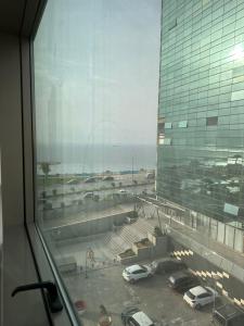 a view of a parking lot from a window at ORAN MOBILART 4 PIECES MODERN apartement in Oran