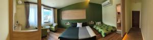 a bedroom with a bed and a green wall at Tu Shu Guan in Guanshan