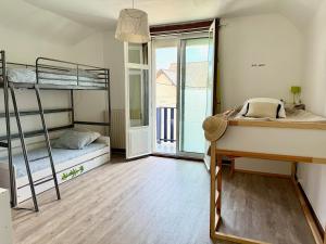 a room with two bunk beds and a window at Les Lutins Villa Le Pouliguen in Le Pouliguen