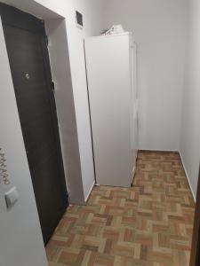a room with a door and a wooden floor at Zețarilor 21A in Bucharest