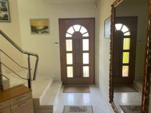 a hallway with two doors and a staircase with a stair case at Вила Рак-Апартаменти за гости in Varna City