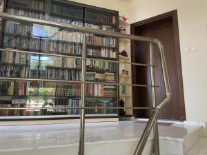 a room with a large window filled with books at Вила Рак-Апартаменти за гости in Varna City +46 photos