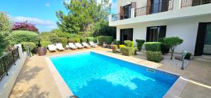a swimming pool in front of a house at Hillside Azure in Polis Chrysochous