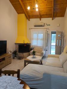 a living room with two beds and a fireplace at Paleros vacation in Paleros