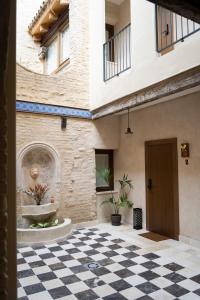 a building with a checkered floor and a fountain at Arena Centro Rooms&Suites, by Homing U in Seville