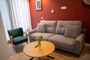 a living room with a couch and a table at Arena Centro Rooms&Suites in Seville