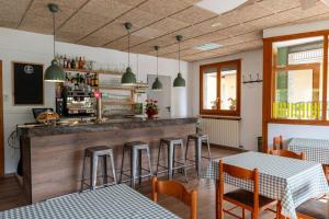 a restaurant with a bar with tables and chairs at Hostal Xic in Sant Pau de Segúries