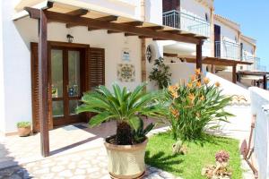 a house with some plants in front of it at Camere da Mariolina in Macari