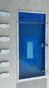 a swimming pool with blue water in a building at Aqua Batumi 44 in Batumi
