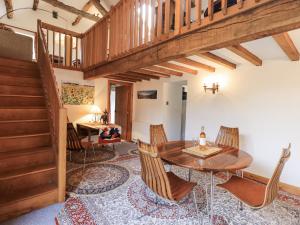 a dining room with a wooden table and chairs at Chapel Cottage in Cleator