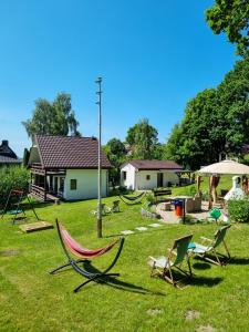 a group of lawn chairs sitting in a yard at Kolonijna Park in Międzyzdroje
