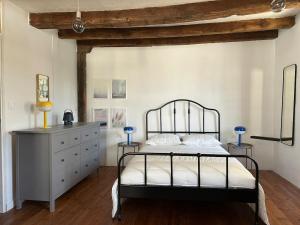 a bedroom with a metal bed and a dresser at Character House in Rochefort-en-Terre +19 photos