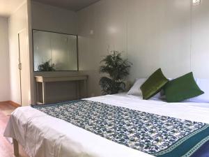 a bedroom with a bed with a mirror and a table at Hope Pension House - Danao in Danao City