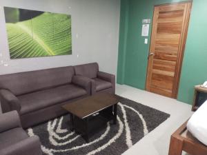 a living room with a couch and a coffee table at Hope Pension House - Danao in Danao City