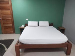 a bed in a room with a white mattress at Hope Pension House - Danao in Danao City