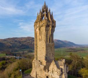 an old stone tower on top of a hill at BOFA Snug Apartment in Bridge of Allan