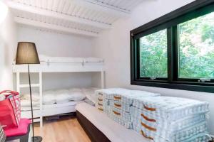 a room with a bed and a window at Peaceful Beach House Life Just 50 M From Shore in Dronningmølle