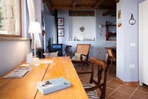 a dining room with a wooden table and chairs at La casina incantata in Trevignano Romano