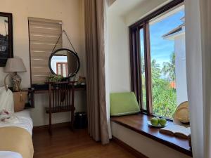 Postel nebo postele na pokoji v ubytování Happy Life Memories Hoi An Hotel & Spa