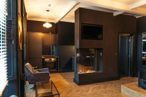 a living room with a fireplace and a chair at Judges suite apartment with spa facilities in Morpeth