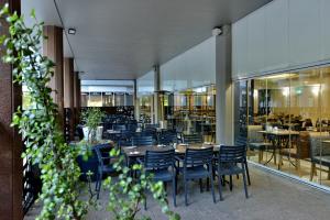 a dining room with chairs and tables and a restaurant at The Capetonian - Halal in Cape Town