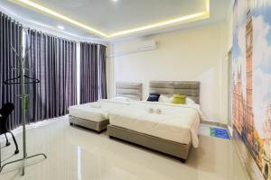 Urbanview Botania Meeting Point Batam by RedDoorz客房内的一张或多张床位
