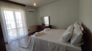 a bedroom with a white bed with two pillows at Terry's House in Fondi