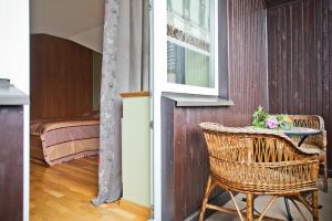 a room with a table and a chair and a window at Adelės Vila in Palanga