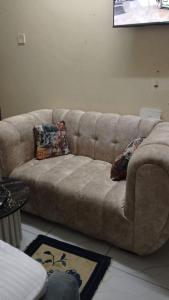 a brown couch sitting in a living room at Lila Homes in Bamburi