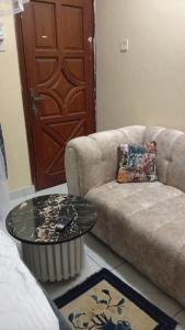 a living room with a couch and a table at Lila Homes in Bamburi