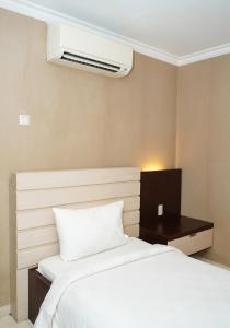 Postel nebo postele na pokoji v ubytování Travellers Suites Serviced Apartments