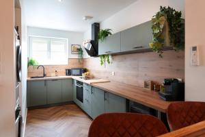 a kitchen with a wooden counter top at Jungle Évasion, Épernay - Jacuzzi & Sauna in Épernay